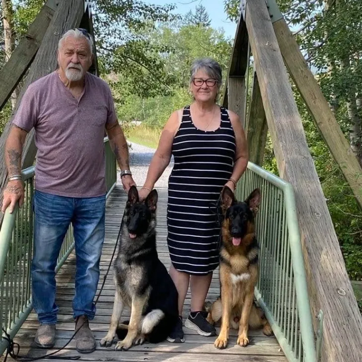 German Shepherd breeder with her husband and dogs